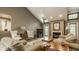 Spacious living room with vaulted ceilings, a cozy fireplace, and comfortable seating at 4428 Edinburgh Pt, Indianapolis, IN 46228