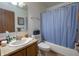 Cozy bathroom with a vanity sink, toilet, and tub with a shower curtain at 4428 Tucson Dr, Indianapolis, IN 46241
