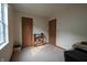 A room that has a table with books and other items, carpeted flooring, and two doors at 4428 Tucson Dr, Indianapolis, IN 46241