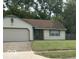 Traditional home featuring white siding, a brown roof, and an attached two-car garage at 4428 Tucson Dr, Indianapolis, IN 46241