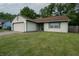 Classic home with white siding, a brown roof, well-maintained lawn, and a two-car garage at 4428 Tucson Dr, Indianapolis, IN 46241