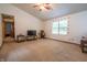 Spacious living room featuring a ceiling fan, neutral walls, and large windows for natural light at 4428 Tucson Dr, Indianapolis, IN 46241
