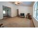 Spacious living room featuring a ceiling fan, neutral walls, and large windows for natural light at 4428 Tucson Dr, Indianapolis, IN 46241