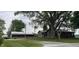 Spacious property featuring a charming home with mature trees, well-manicured lawns, and additional outbuildings at 4849 S 500 E, Greenfield, IN 46140
