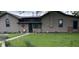 Quaint home featuring neutral siding and a metal roof, complemented by a well-maintained lawn and decorative accents at 4849 S 500 E, Greenfield, IN 46140