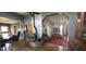 Inviting living room featuring a classic wood-burning stove, hardwood floors, and an open layout leading to the dining area at 4849 S 500 E, Greenfield, IN 46140