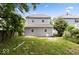 Spacious backyard with a two-story house and a chair, perfect for outdoor relaxation at 4923 E University Ave, Indianapolis, IN 46201