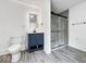 Modern bathroom features a stylish vanity, sleek mirror and a glass-enclosed shower with gray tile at 4923 E University Ave, Indianapolis, IN 46201
