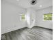 Bright bedroom with gray flooring, white walls, and natural light from two windows at 4923 E University Ave, Indianapolis, IN 46201