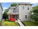 Charming two-story home featuring a red-brick porch, gray siding, and a well-maintained lawn at 4923 E University Ave, Indianapolis, IN 46201