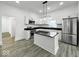 Stylish kitchen with stainless appliances, an island, and modern lighting fixtures at 4923 E University Ave, Indianapolis, IN 46201