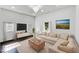 Bright living room featuring a plush sectional sofa, modern chandelier, and contemporary decor at 4923 E University Ave, Indianapolis, IN 46201