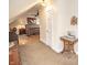 Neutral attic room features comfortable bed, ceiling fan, sewing table and other homey touches at 5024 N Kenwood Ave, Indianapolis, IN 46208