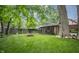 Green backyard featuring a firepit, tree swing, and a screened-in porch at 5024 N Kenwood Ave, Indianapolis, IN 46208