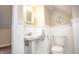 Classic bathroom features a pedestal sink, toilet, and wainscoting at 5024 N Kenwood Ave, Indianapolis, IN 46208