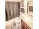 Well-maintained bathroom with a shower-tub, granite vanity, and ample storage at 5024 N Kenwood Ave, Indianapolis, IN 46208