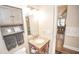 Well-lit bathroom with a granite vanity, plenty of storage, and access to the dining room at 5024 N Kenwood Ave, Indianapolis, IN 46208