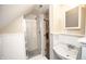 Neat bathroom showcasing shower, wainscoting, and a classic sink at 5024 N Kenwood Ave, Indianapolis, IN 46208
