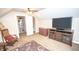 Spacious bedroom with a TV, rocking chair, and doorway to another room at 5024 N Kenwood Ave, Indianapolis, IN 46208