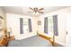Relaxing bedroom with ample natural light, neutral walls, hardwood floors, and ceiling fan at 5024 N Kenwood Ave, Indianapolis, IN 46208