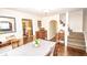Charming dining room showcasing hardwood floors, staircase and seamless connection to the kitchen at 5024 N Kenwood Ave, Indianapolis, IN 46208