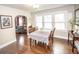Inviting dining room with hardwood floors, large windows, and an archway to the living room at 5024 N Kenwood Ave, Indianapolis, IN 46208
