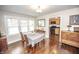 Bright dining room featuring hardwood floors, natural light, and seamless flow into the adjacent kitchen at 5024 N Kenwood Ave, Indianapolis, IN 46208