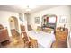 Warm dining room with hardwood floors, staircase, and a view into the cozy living room at 5024 N Kenwood Ave, Indianapolis, IN 46208