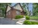 Lovely brick Tudor-style house featuring a well-manicured lawn and classic architectural details at 5024 N Kenwood Ave, Indianapolis, IN 46208