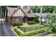 Aerial view of a brick Tudor-style home featuring a well-kept lawn and classic curb appeal at 5024 N Kenwood Ave, Indianapolis, IN 46208