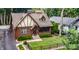 Aerial view of a charming brick Tudor home with a manicured lawn and a fenced yard at 5024 N Kenwood Ave, Indianapolis, IN 46208