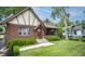 Inviting Tudor-style home with a brick facade, arched entryway, and well-kept front lawn at 5024 N Kenwood Ave, Indianapolis, IN 46208