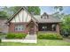 Charming brick Tudor home with arched entry, covered porch, and manicured front yard at 5024 N Kenwood Ave, Indianapolis, IN 46208