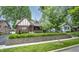 Beautiful Tudor-style home featuring a brick facade, manicured landscaping, and classic design at 5024 N Kenwood Ave, Indianapolis, IN 46208