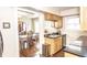 Charming kitchen with wood cabinets, black countertops, stainless steel appliances, and view of dining area at 5024 N Kenwood Ave, Indianapolis, IN 46208