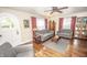 Cozy living room with hardwood floors, ceiling fan, and two sofas at 5024 N Kenwood Ave, Indianapolis, IN 46208
