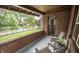Cozy porch features brick, seating and views of the lawn and street at 5024 N Kenwood Ave, Indianapolis, IN 46208