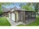 Enclosed screened-in porch with outdoor furniture, attached to the home's exterior at 5024 N Kenwood Ave, Indianapolis, IN 46208