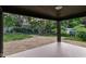 Back porch with wooded scenery and landscaping at 5884 Compton St, Indianapolis, IN 46220