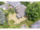 Aerial backyard view featuring a patio, fence, garden beds, and a well maintained lawn at 5884 Compton St, Indianapolis, IN 46220