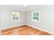 Bright bedroom featuring hardwood floors and two windows offering natural light at 5884 Compton St, Indianapolis, IN 46220