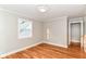 Sunlit bedroom featuring hardwood flooring and fresh paint at 5884 Compton St, Indianapolis, IN 46220