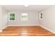 Bedroom featuring hardwood floors, neutral paint, and windows with outside views at 5884 Compton St, Indianapolis, IN 46220
