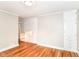 Bedroom showcasing hardwood floors, built-in cabinets, and neutral wall colors at 5884 Compton St, Indianapolis, IN 46220