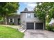 Picture of house featuring a two-car garage, well-kept lawn and mature trees at 5884 Compton St, Indianapolis, IN 46220