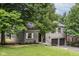 Charming exterior view with a two-car garage, dark roof, and well-maintained lawn at 5884 Compton St, Indianapolis, IN 46220