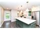 Bright kitchen with an island, stainless steel appliances, and modern pendant lighting at 5884 Compton St, Indianapolis, IN 46220