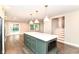 Open kitchen featuring a center island, stainless steel appliances, and hardwood floors at 5884 Compton St, Indianapolis, IN 46220