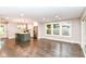 Bright living room with hardwood floors, an island with pendant lights, stainless appliances, and large windows at 5884 Compton St, Indianapolis, IN 46220
