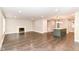Spacious living room featuring hardwood floors, a fireplace, and an island with pendant lighting at 5884 Compton St, Indianapolis, IN 46220